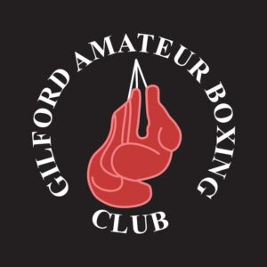 Gilford Amateur Boxing Club is printed in a circle in white lettering on a black background. A graphic of a pair of red boxing gloves hangs in the middle of the text circle